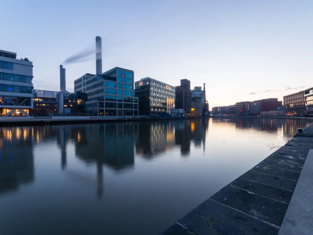 Moderner Stadthafen Münster mit Bürogebäuden und Wasser als regionales Motiv für Factoring Münster.